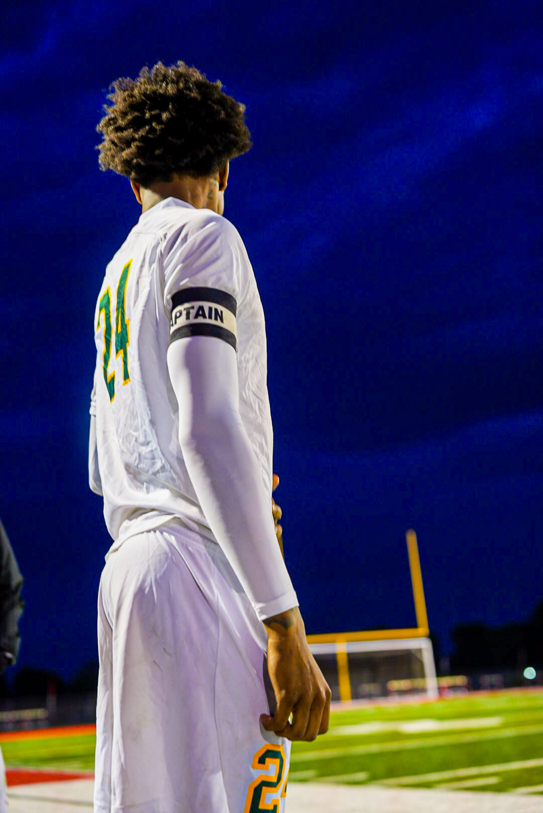 Cedar Rapids soccer captain photographed under stadium lights by Fedeli Photos